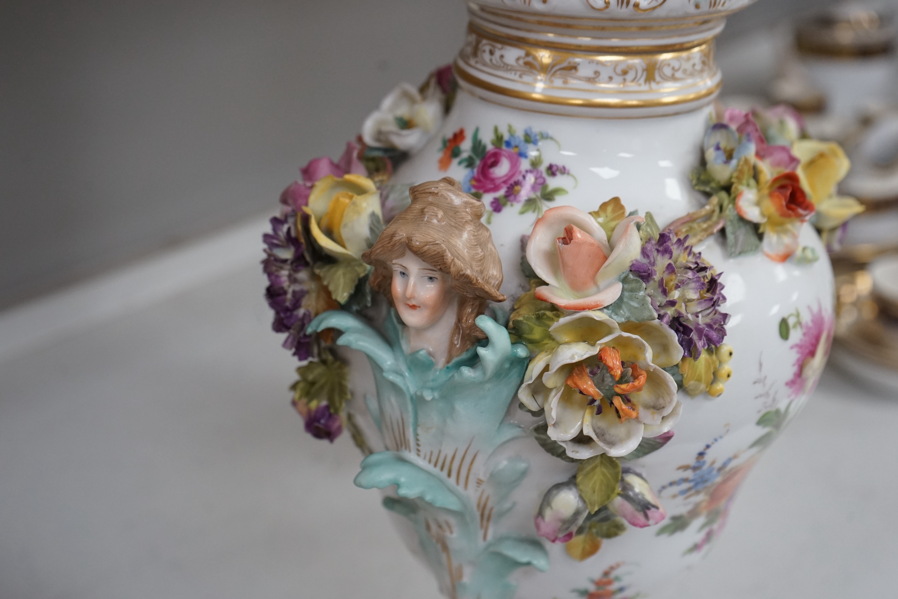 A Dresden floral encrusted porcelain incense burner hand painted with figures annd flowers, together with a similar lidded box, largest 52cm high. Condition - some losses